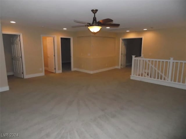 spare room with light colored carpet and ceiling fan