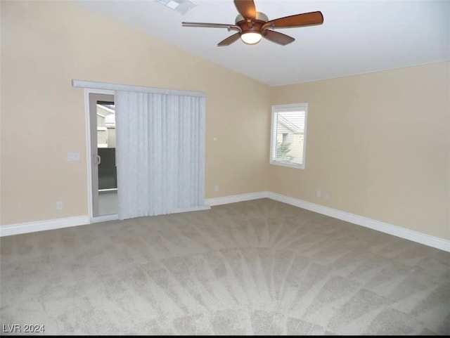 carpeted empty room featuring ceiling fan and lofted ceiling