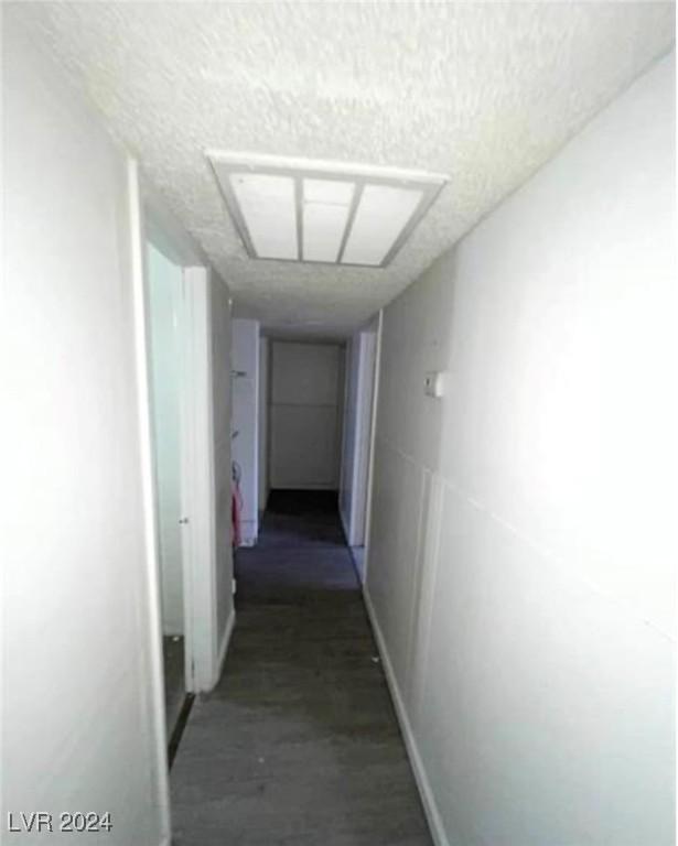 hallway with a textured ceiling