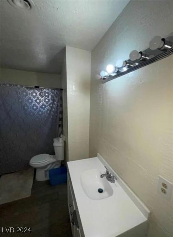 bathroom featuring toilet and vanity