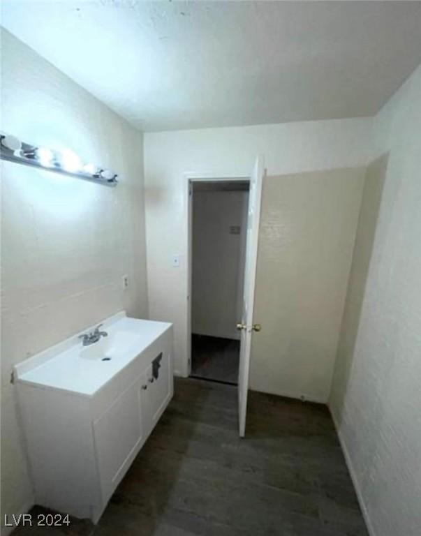 bathroom with hardwood / wood-style flooring and vanity