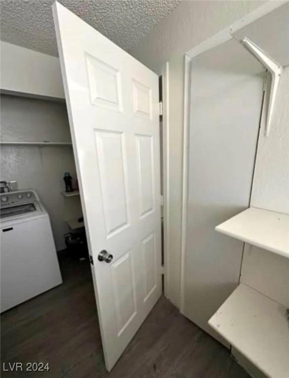 interior space featuring washer / dryer, a textured ceiling, and hardwood / wood-style flooring