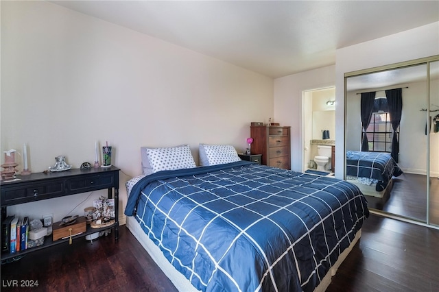 bedroom with connected bathroom, dark hardwood / wood-style flooring, and a closet