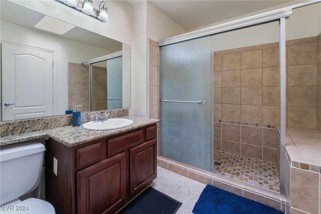 bathroom featuring vanity, walk in shower, toilet, and tile patterned flooring