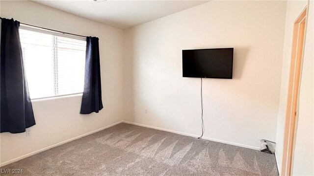 interior space with carpet flooring and baseboards