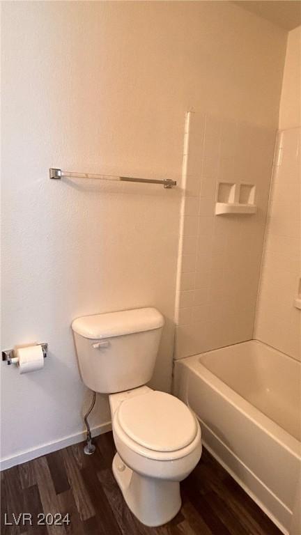 full bathroom with toilet, wood finished floors, and baseboards