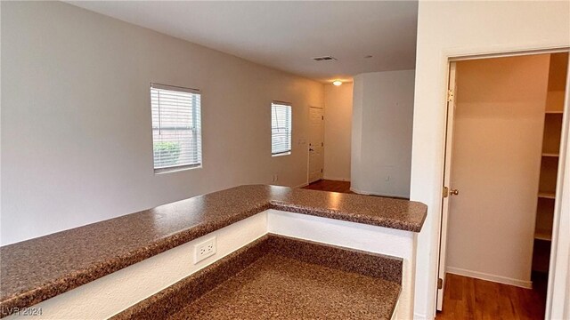 interior space with wood finished floors and visible vents