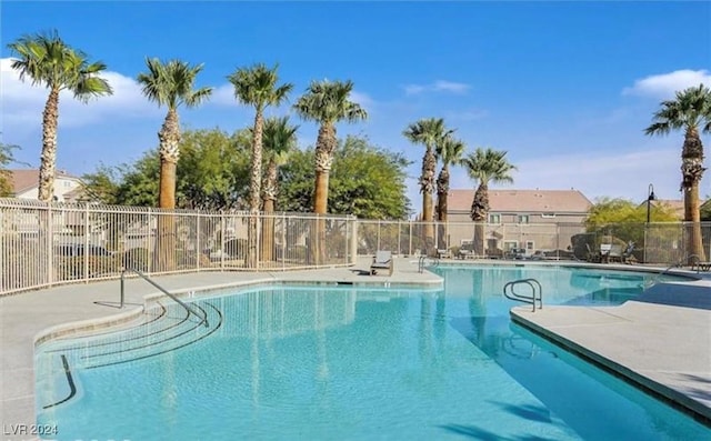 community pool featuring a patio area and fence