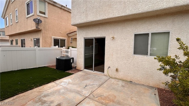 back of house featuring central AC unit, a patio area, fence, and stucco siding