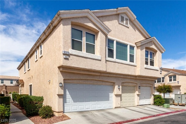 9333 Leaping Deer Pl Unit 102, Las Vegas, NV 89178 - townhome / multi-family property with stucco siding, a garage, and driveway