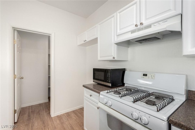 9333 Leaping Deer Pl Unit 102, Las Vegas, NV 89178 - kitchen featuring white gas stove, black microwave, under cabinet range hood, and dark countertops
