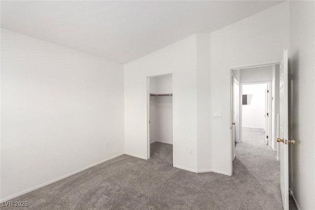 9333 Leaping Deer Pl Unit 102, Las Vegas, NV 89178 - unfurnished bedroom with vaulted ceiling, carpet floors, a spacious closet, and baseboards