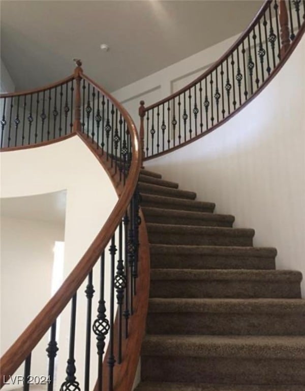 stairs featuring a high ceiling