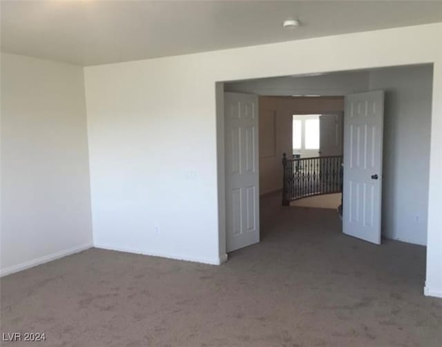 unfurnished room featuring carpet flooring