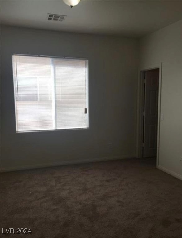 unfurnished room with plenty of natural light and carpet floors