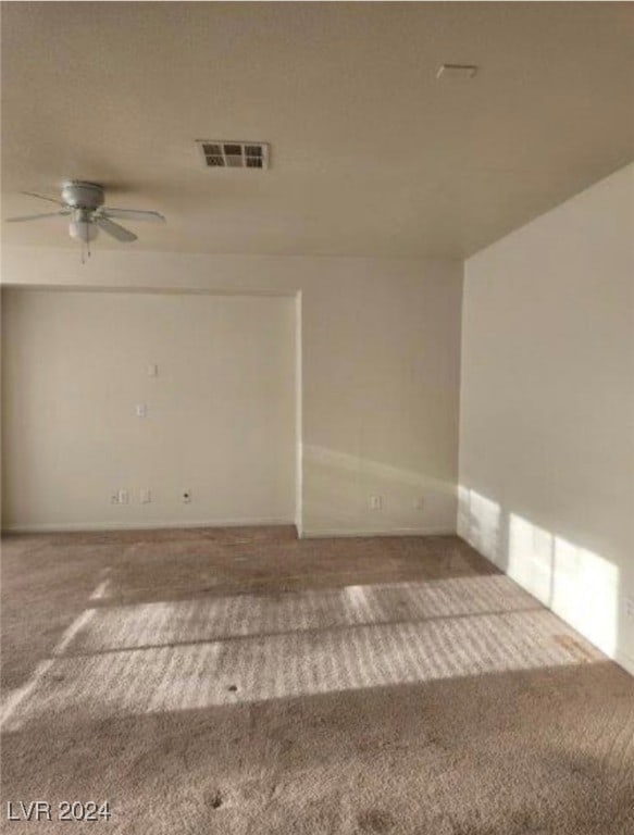 spare room with carpet and ceiling fan