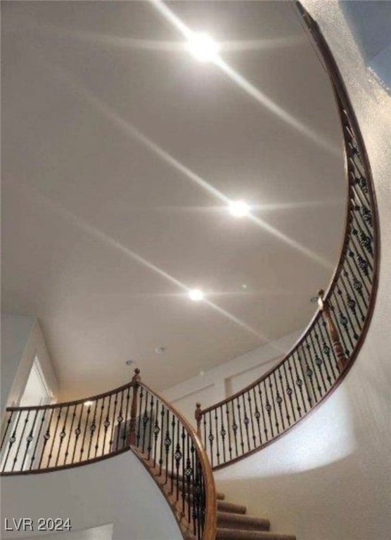 staircase featuring a high ceiling