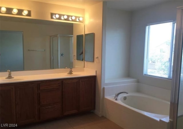 bathroom featuring double vanity, tile patterned floors, and independent shower and bath