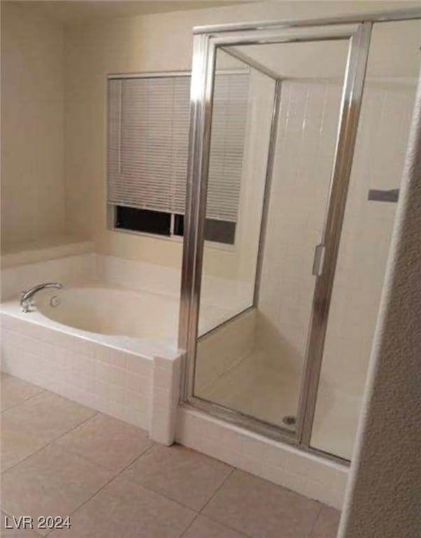 bathroom with tile patterned flooring and independent shower and bath