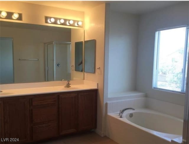 bathroom with double sink vanity and plus walk in shower