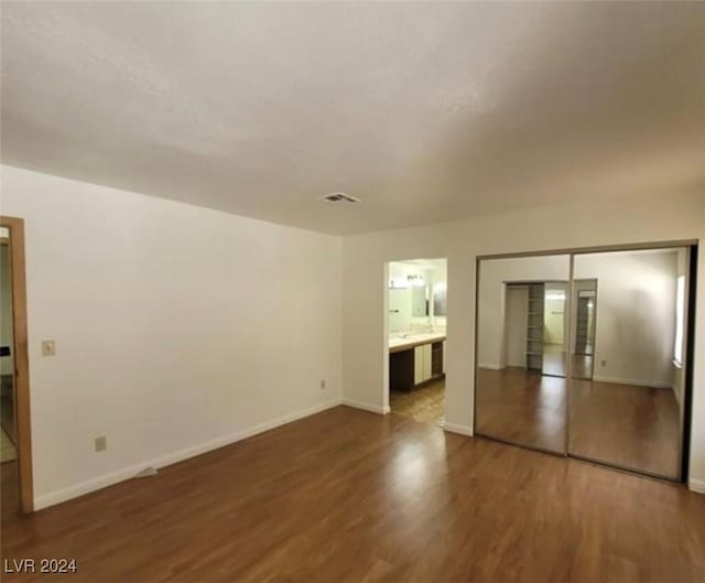 spare room featuring dark wood-type flooring