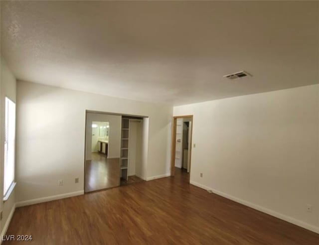 spare room with dark hardwood / wood-style flooring