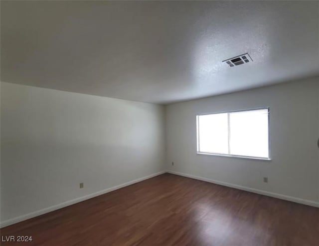 empty room featuring dark wood-type flooring