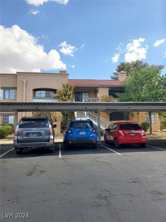 view of vehicle parking featuring a carport