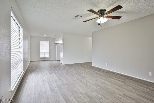 unfurnished living room with ceiling fan, a textured ceiling, and light wood-type flooring