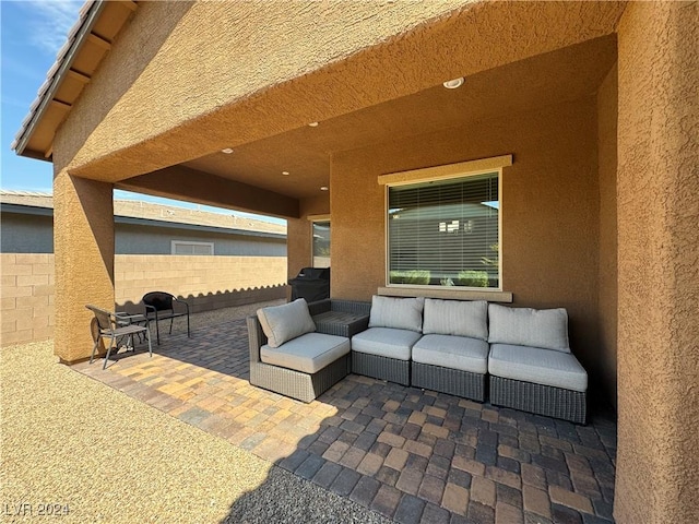 view of patio featuring fence and an outdoor hangout area