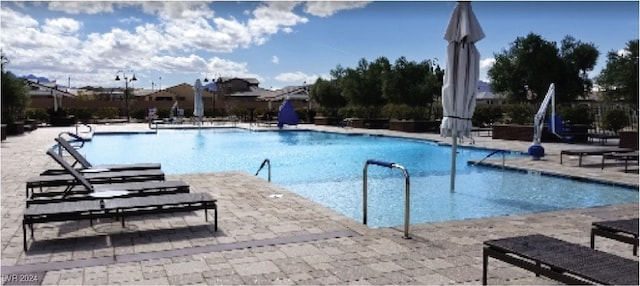 community pool with a patio area