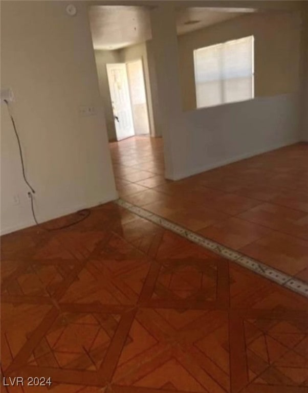 unfurnished room with parquet flooring