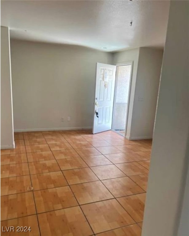 unfurnished room featuring light tile patterned floors