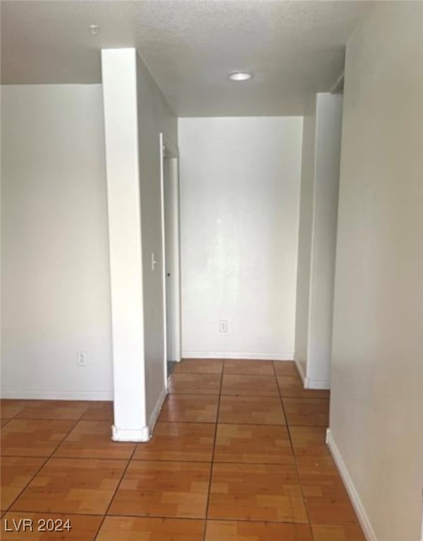 corridor featuring tile patterned flooring