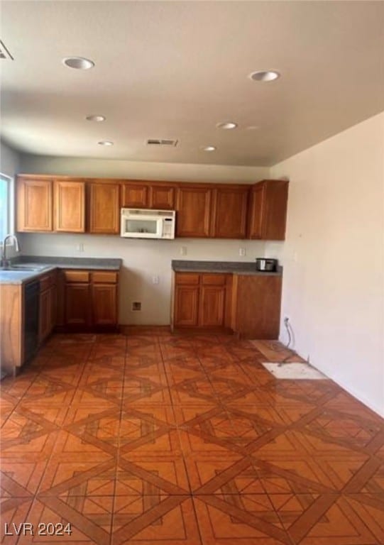 kitchen featuring sink and black dishwasher