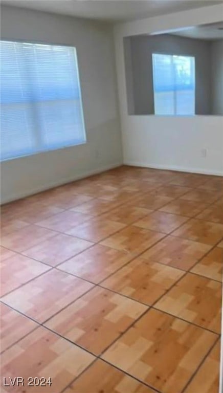 spare room featuring light tile patterned floors