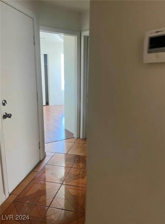 corridor featuring light tile patterned flooring