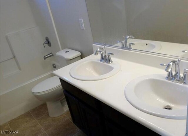 full bathroom with shower / tub combination, vanity, tile patterned flooring, and toilet