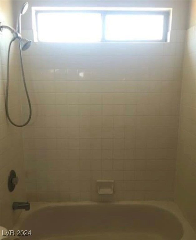 interior space featuring tiled shower / bath combo