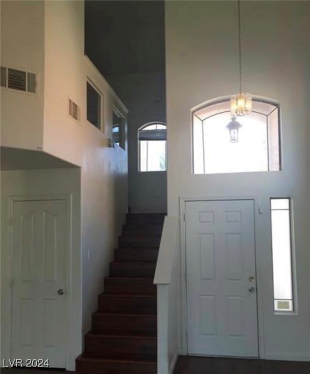 entrance foyer featuring a high ceiling and a healthy amount of sunlight