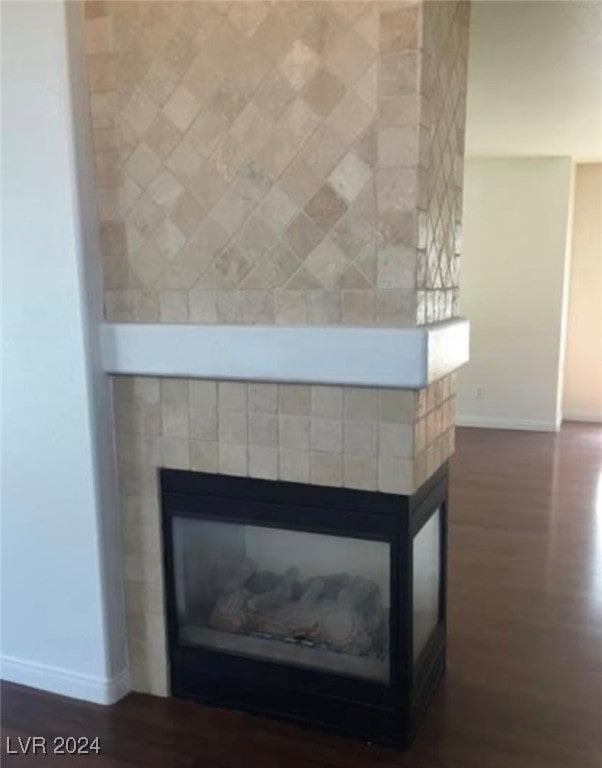 details with hardwood / wood-style floors and a multi sided fireplace