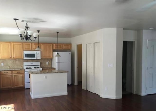 kitchen with white appliances, dark hardwood / wood-style floors, light stone countertops, an inviting chandelier, and decorative light fixtures