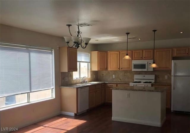 kitchen featuring light brown cabinets, white appliances, an inviting chandelier, and pendant lighting