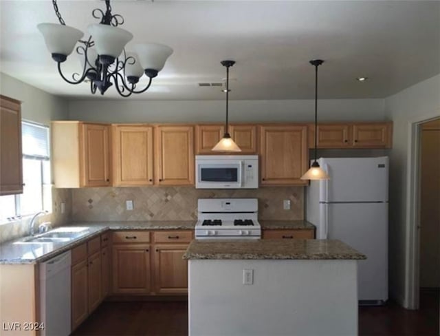 kitchen featuring decorative backsplash, a chandelier, a center island, white appliances, and sink