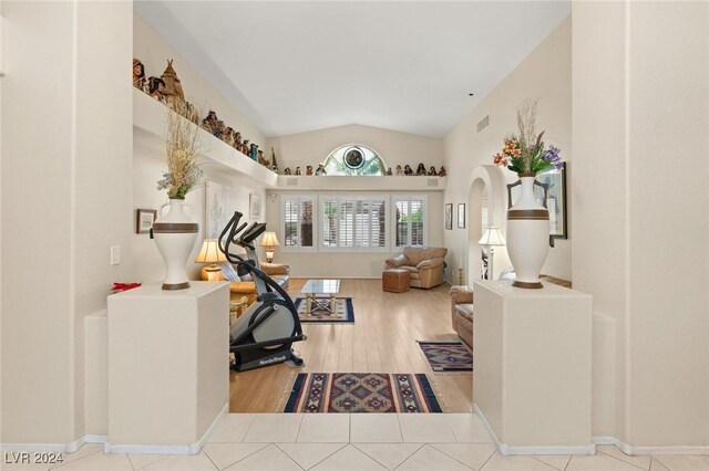 interior space featuring vaulted ceiling and light hardwood / wood-style floors