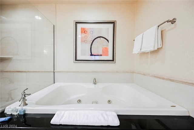 full bath featuring a jetted tub