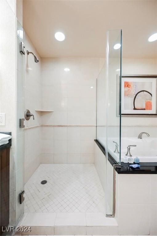bathroom with a shower stall, vanity, and recessed lighting