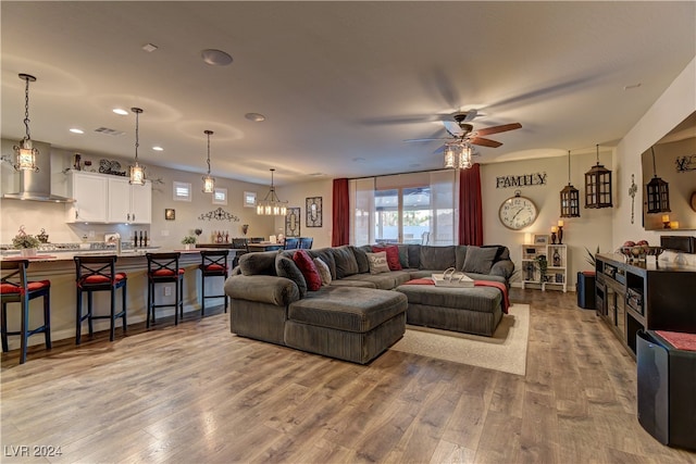 living room featuring light wood-type flooring and ceiling fan