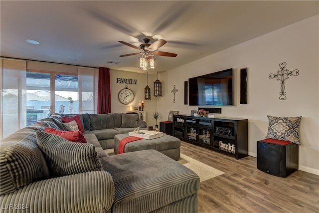 living room featuring ceiling fan and hardwood / wood-style floors