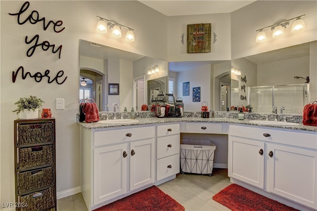 bathroom featuring dual bowl vanity and tile patterned floors